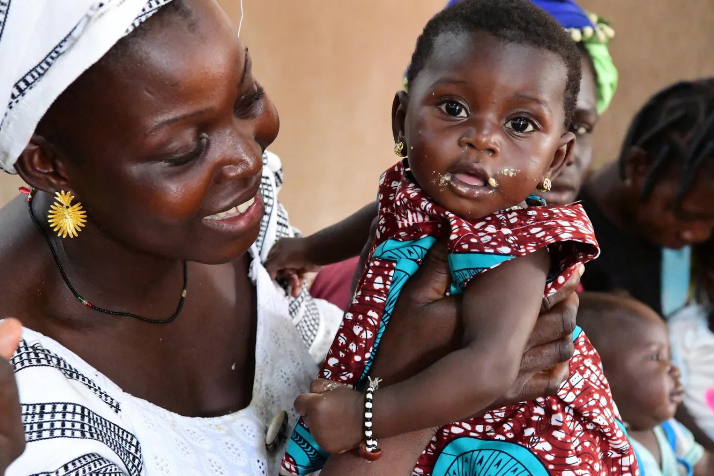 A mother is cuddling her baby while she&rsquo;s waiting for her baby to be weighted, measured and vaccinated, in the health center of Kaya, in the North of Burkina Faso.