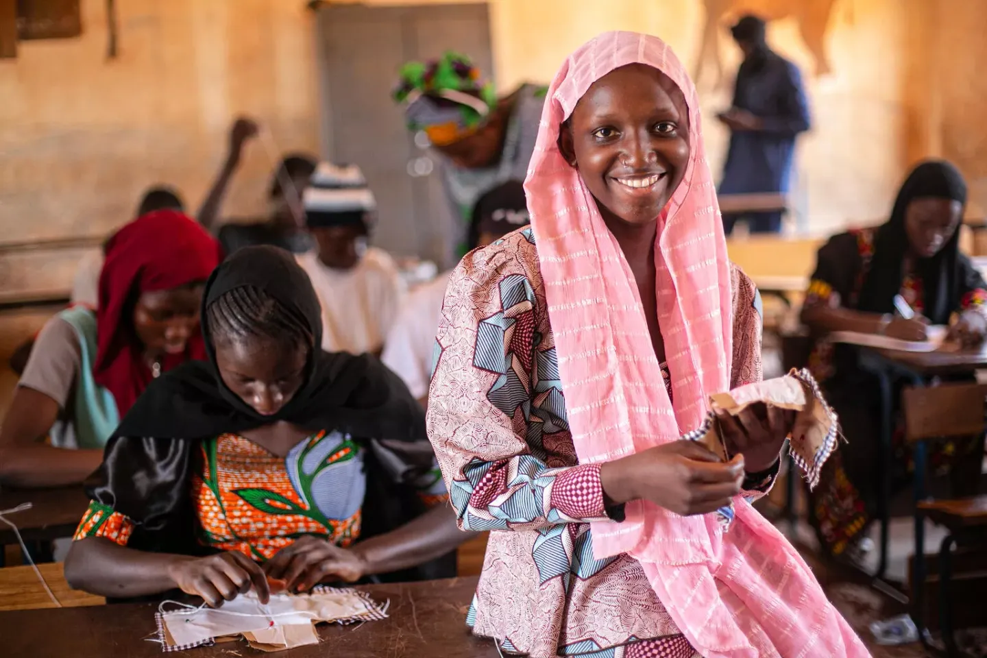 Girls learning how to make reusable pads