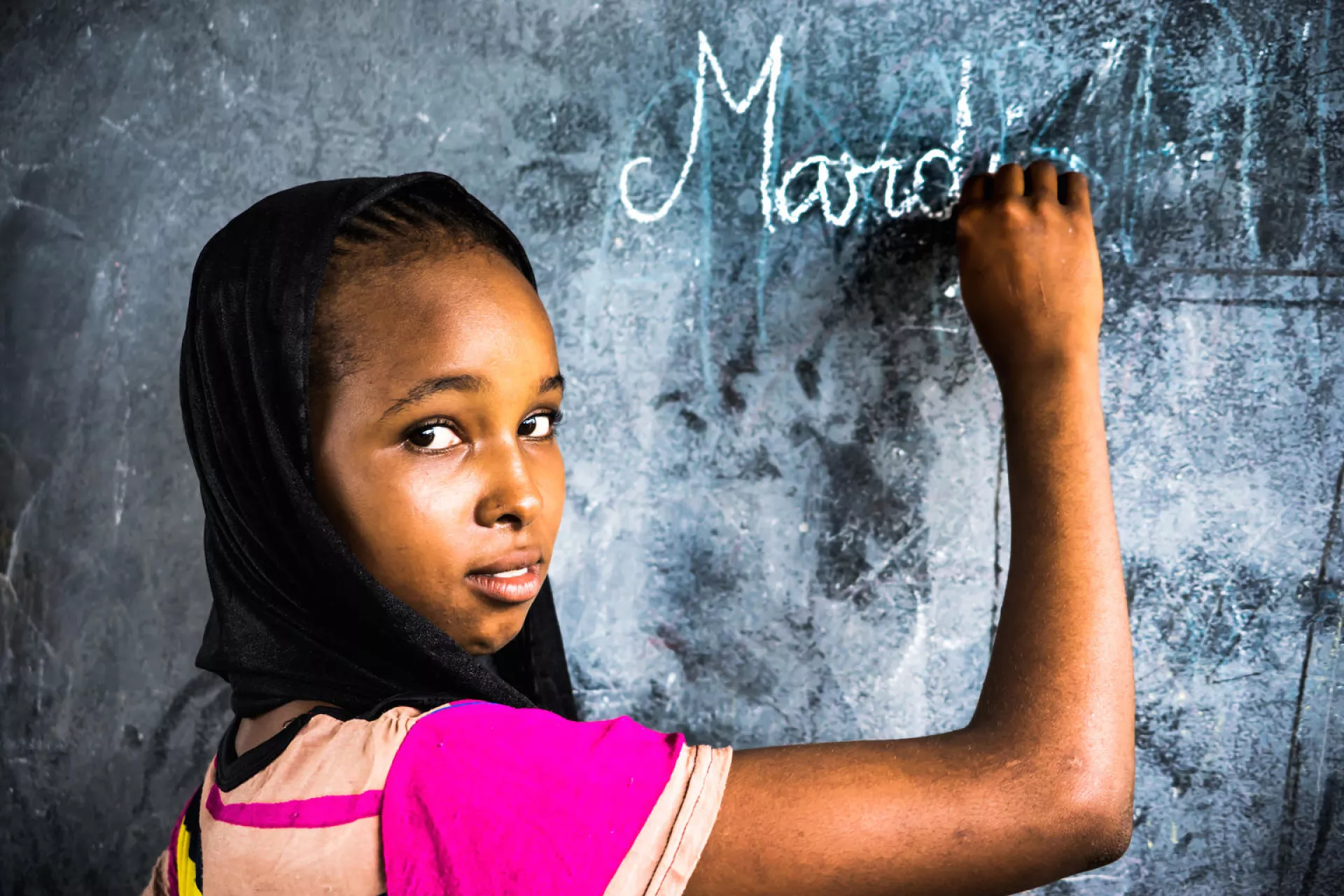 Hawa Oimar, 15, who is in grade CM1, writes on a blackboard in a classroom at the school she attends in Danamadja, southern Chad, Tuesday 13 June 2017.
