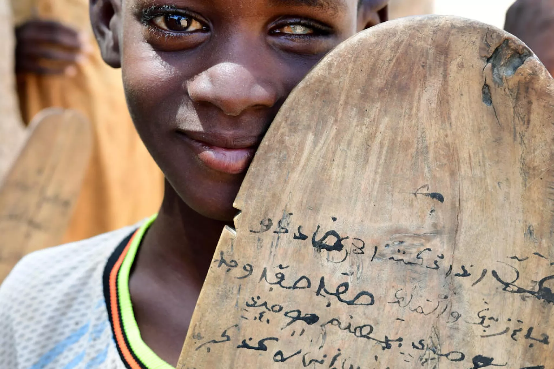 Portrait of a young boy who is visually impaired attending his Koranic school