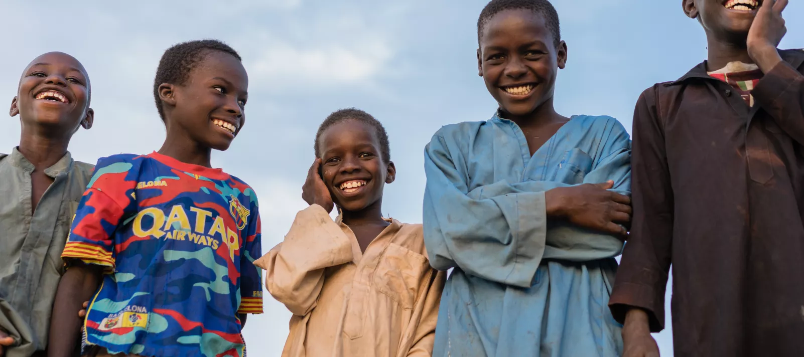 Five children laugh at the camera