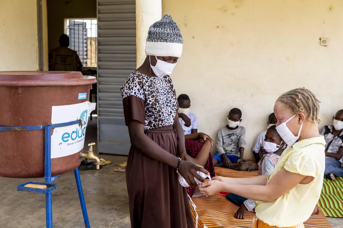 Zara 15 years, is helping her friend to wash her hands