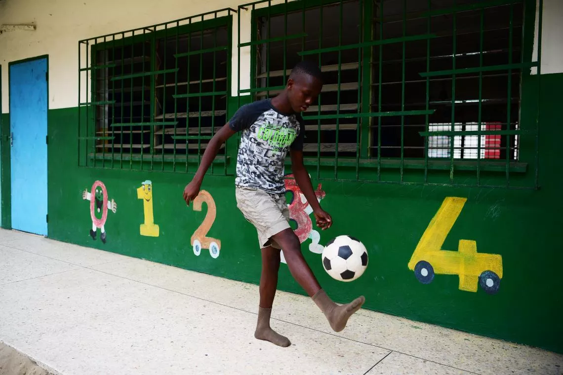 Amadou, 16, bounces a ball at a child protection centre in Abobo, a suburb of Abidjan, Côte d’Ivoire.