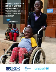 A young child smiling as he is being pushed by his friend as he sits on his wheelchair