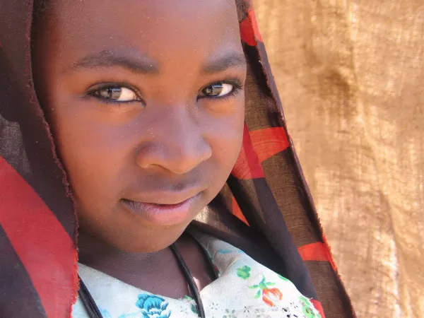 A girl helps her mother run a tea stall in the town of Korma in North Darfur. 