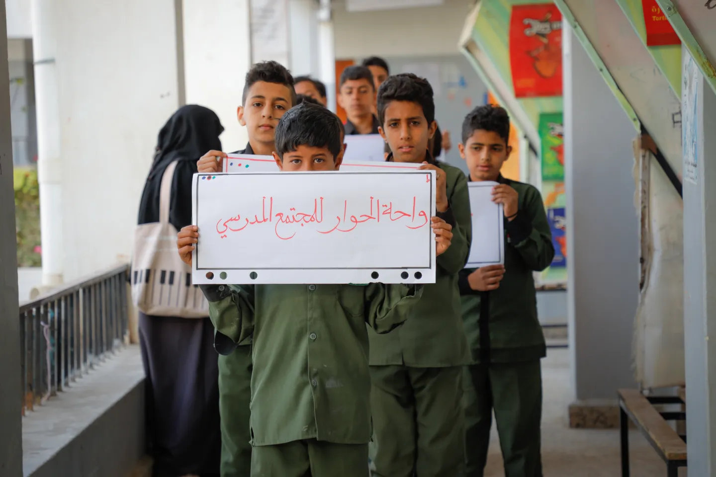 school boys holding a sign