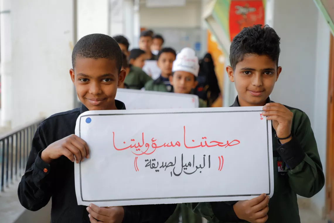 school boys holding a sign