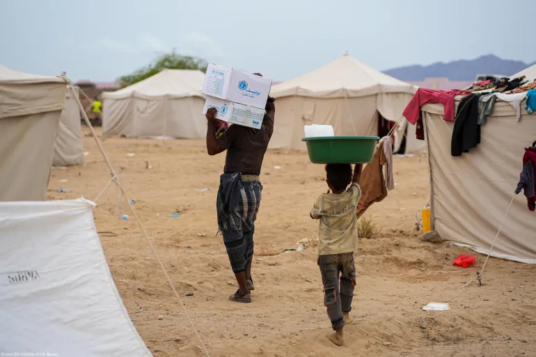 Displaced people carries their aid box