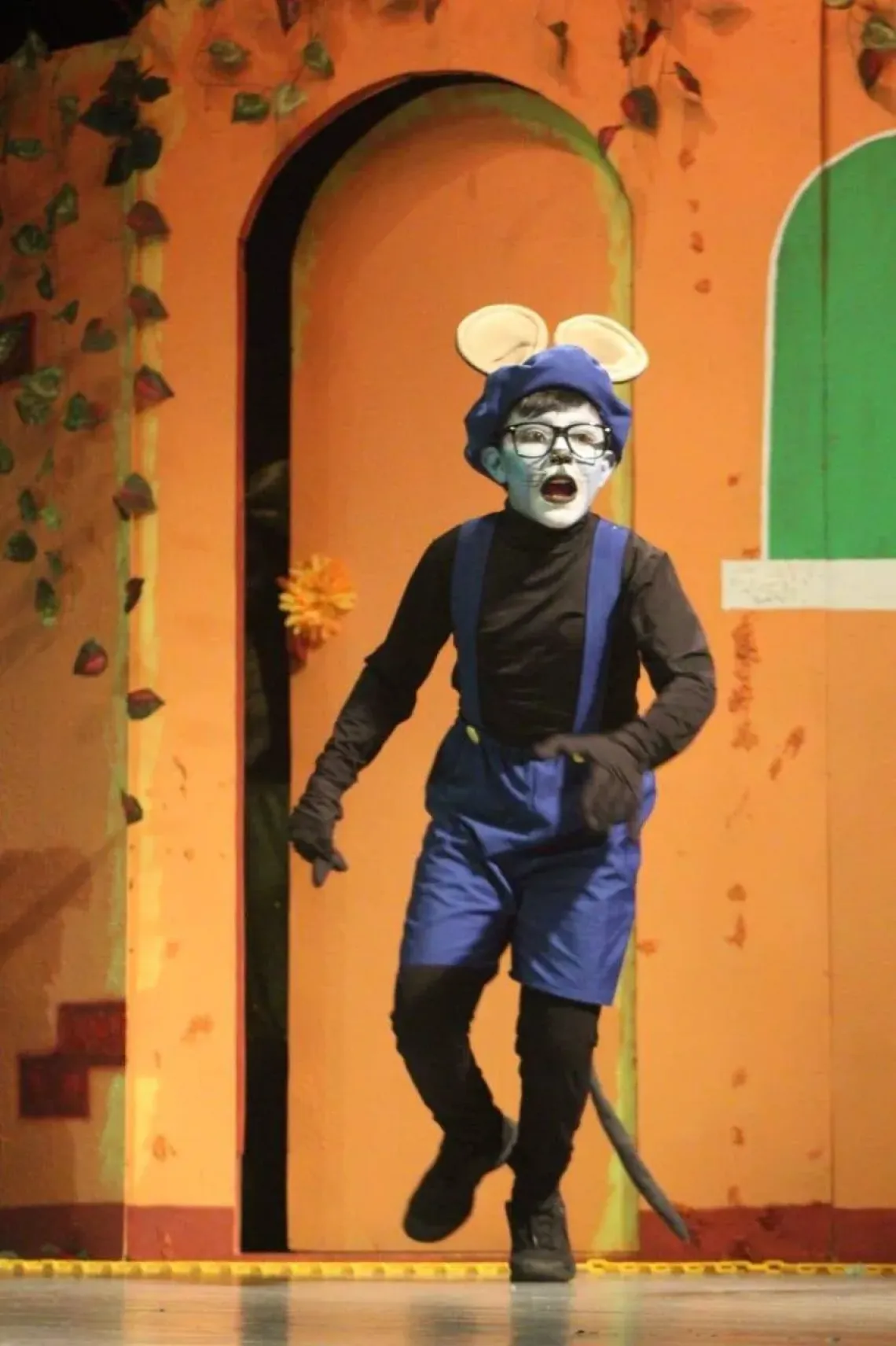 a boy dressed as a mouse in a school play