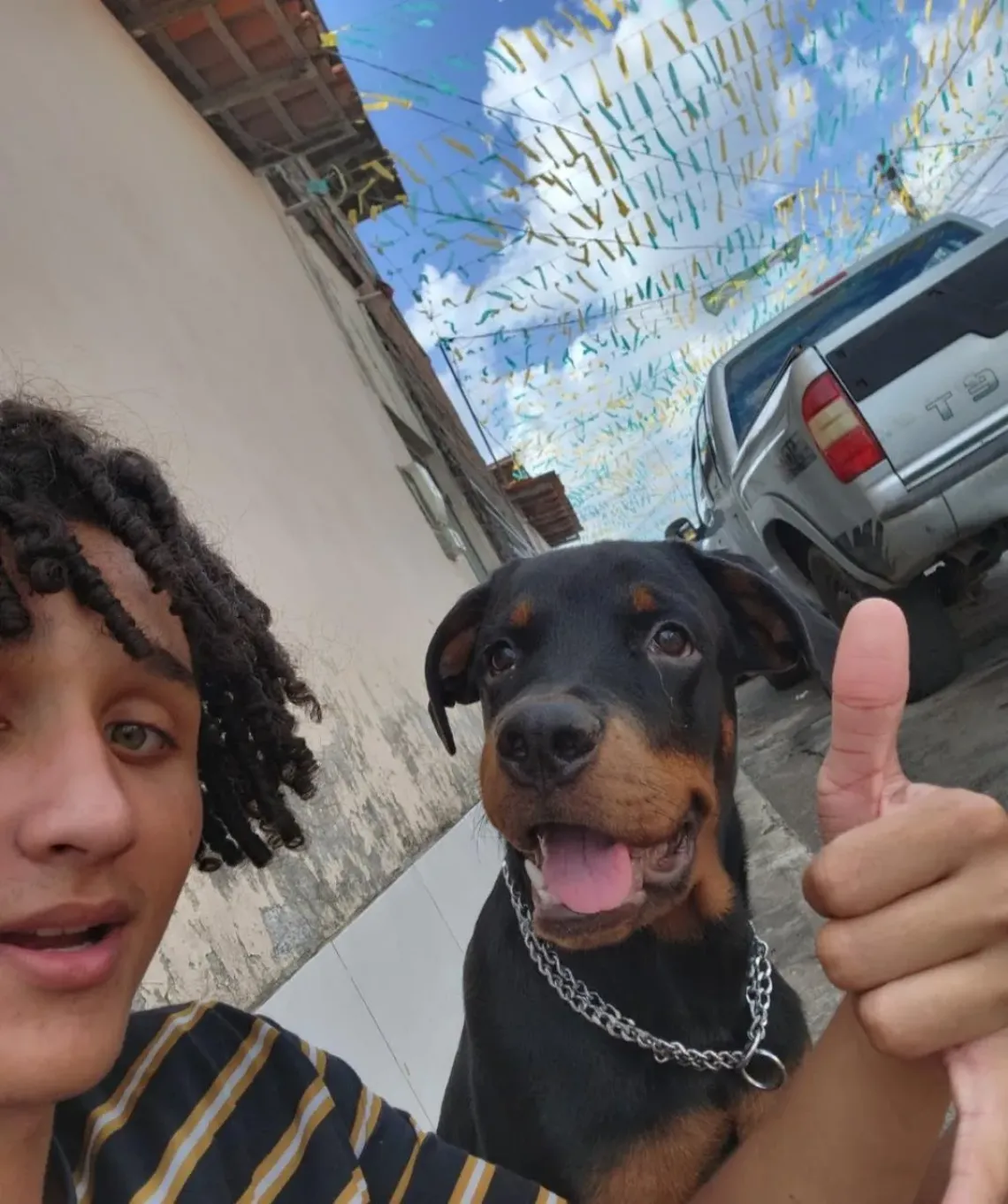 A young boy smiling next to a dog