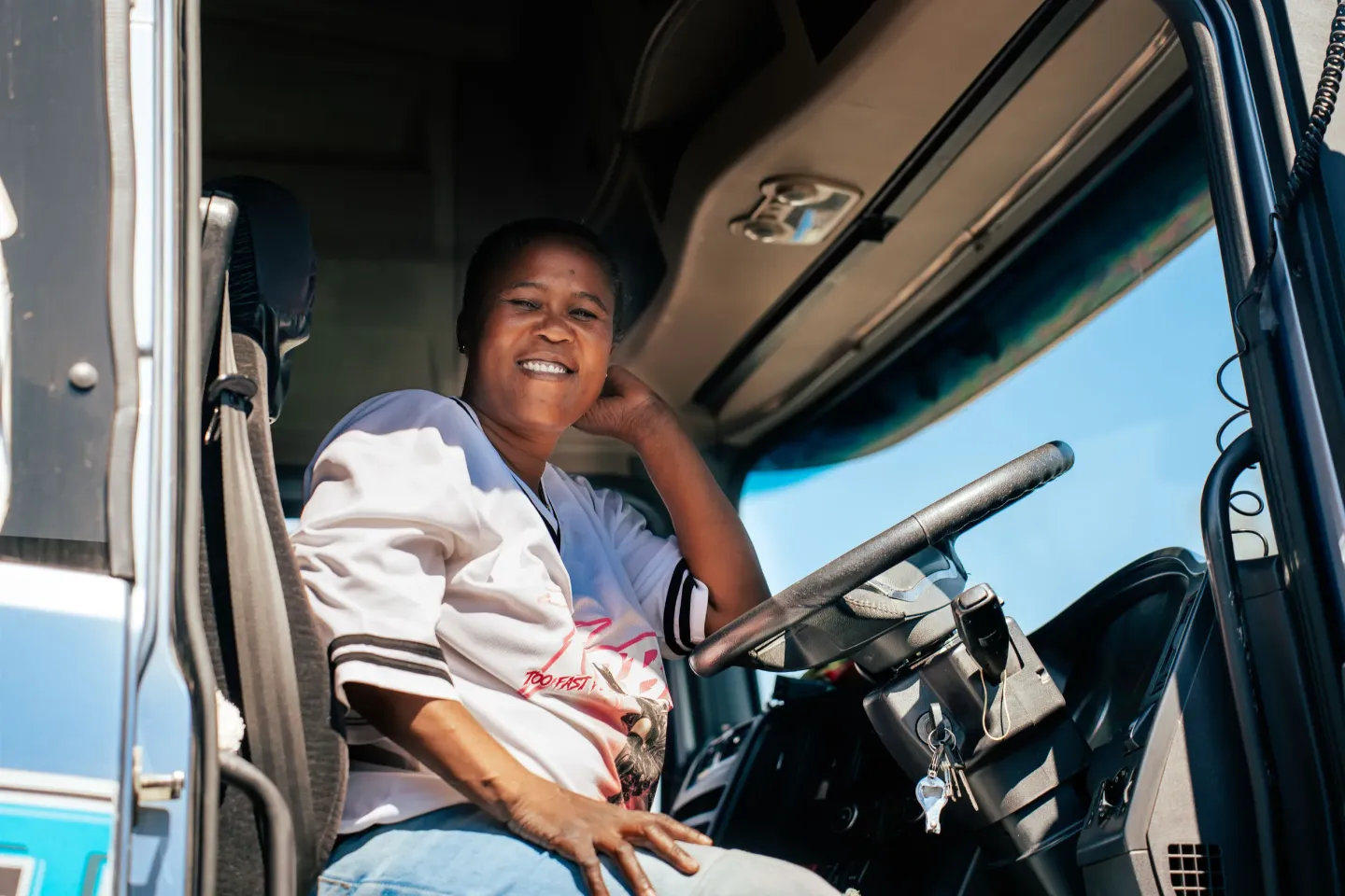 Female long-distance truck driver Lovely Mukupa poses for a photo in her truck during the interview.
