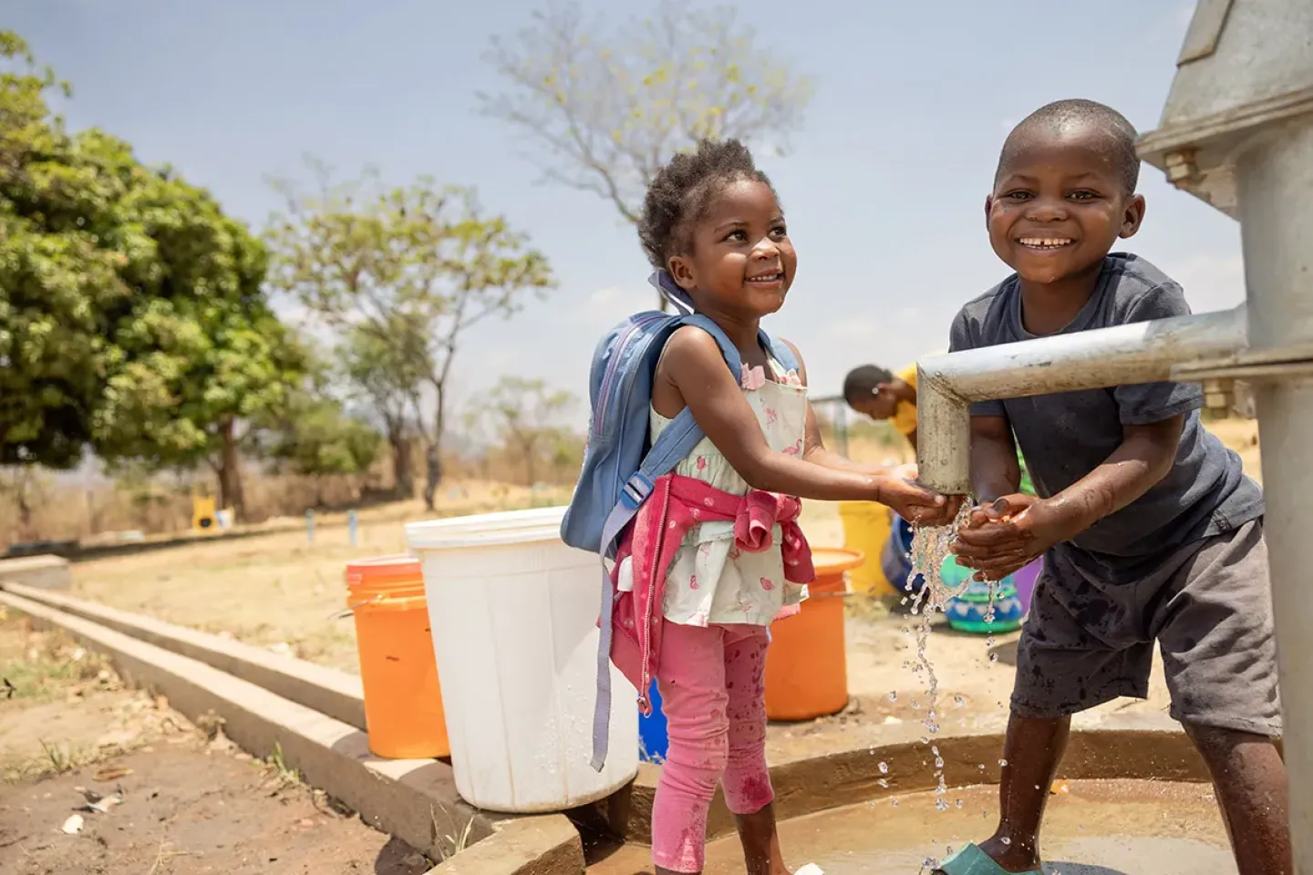 Children practice handwashing outside their Mphala in Chipata, Eastern province.