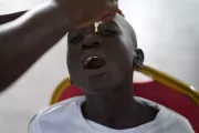 A boy receiving a cholera vaccine.