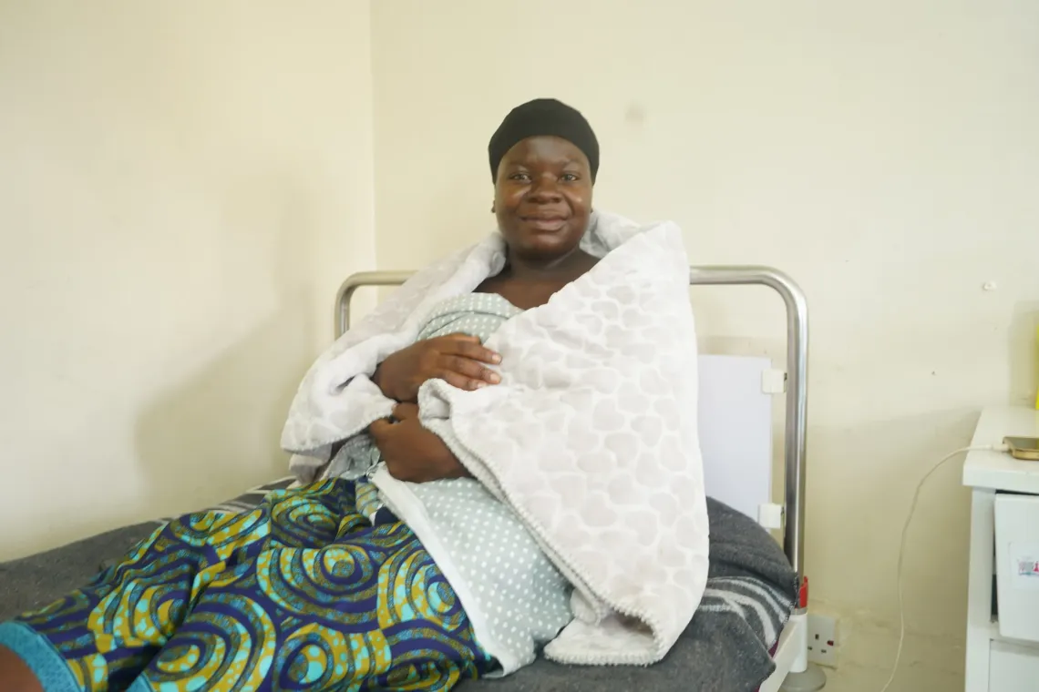 A mother holds her newborn at Chifunabuli District Hospital, Luapula Province.