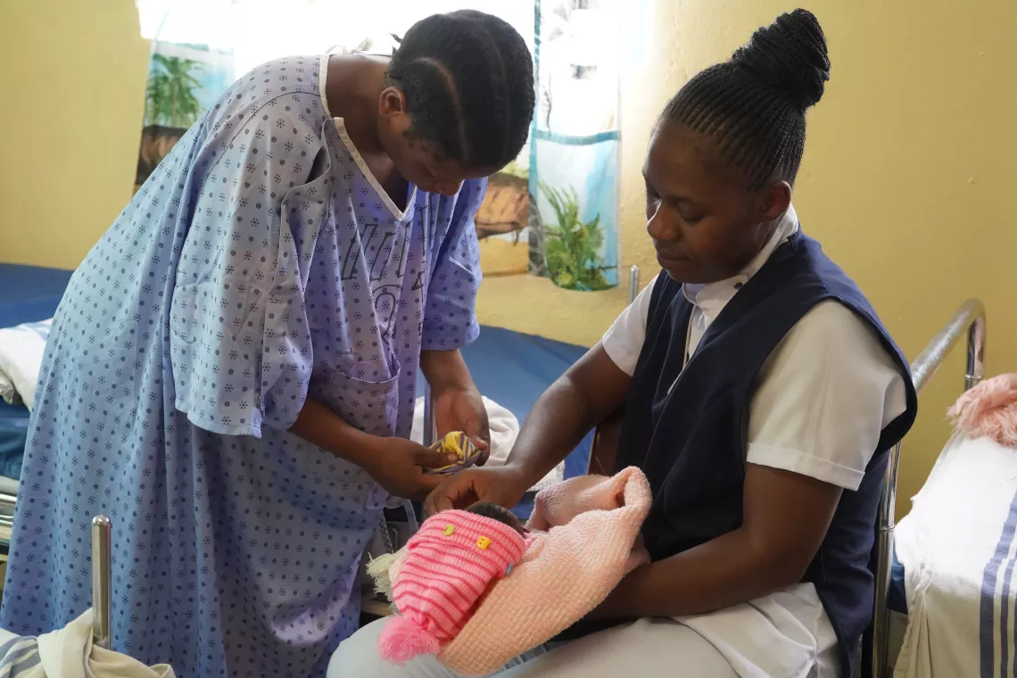 Registered Nurse Faides Zulu and Mother Mary Zulu preparing the baby for Kangaroo Mother Care 