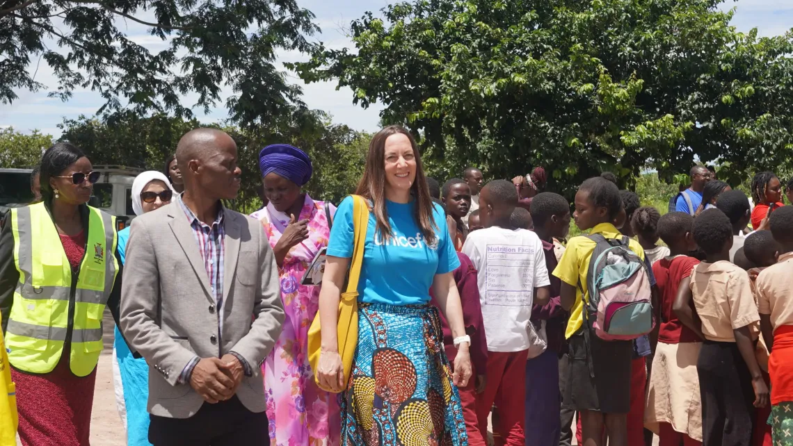 UNICEF officials and district representatives arrive at a school and are welcomed by learners in Chifunabuli District, Luapula Province.