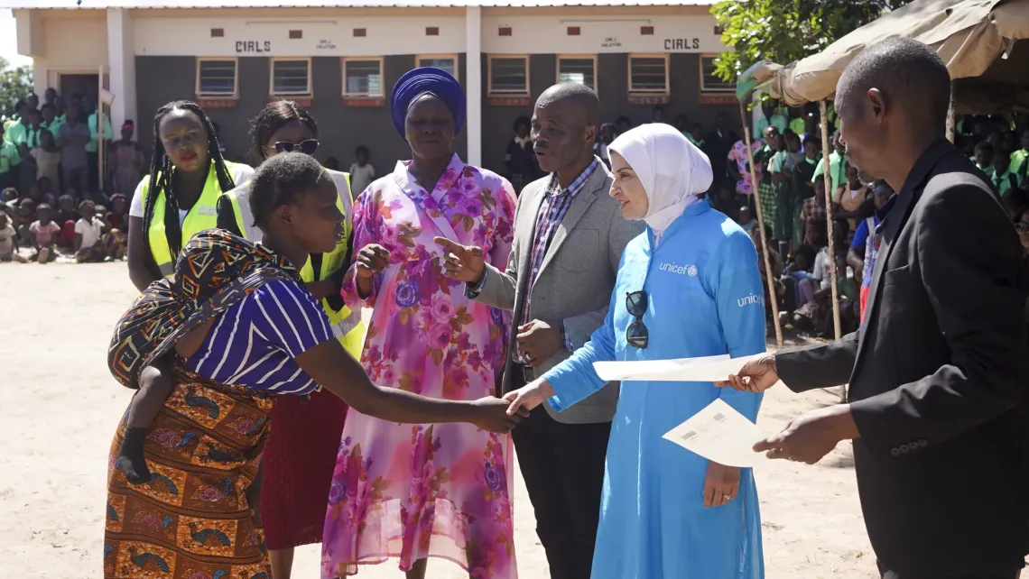 Dr. Saja Farooq Abdullah greets a young mother during a community engagement in Chifunabuli District, Luapula Province.