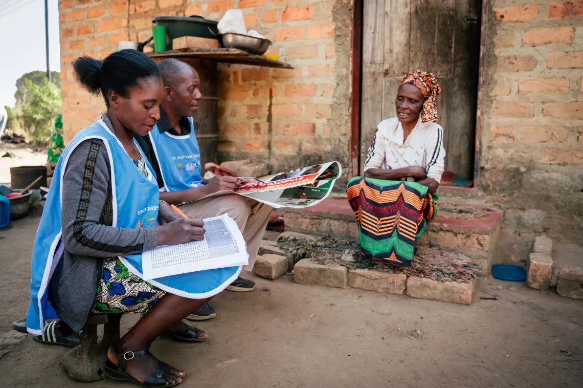 Cletus Mukonka and Judith Biemba, Community based volunteers conducting door to door sensitizations in Kazombo village Monze.