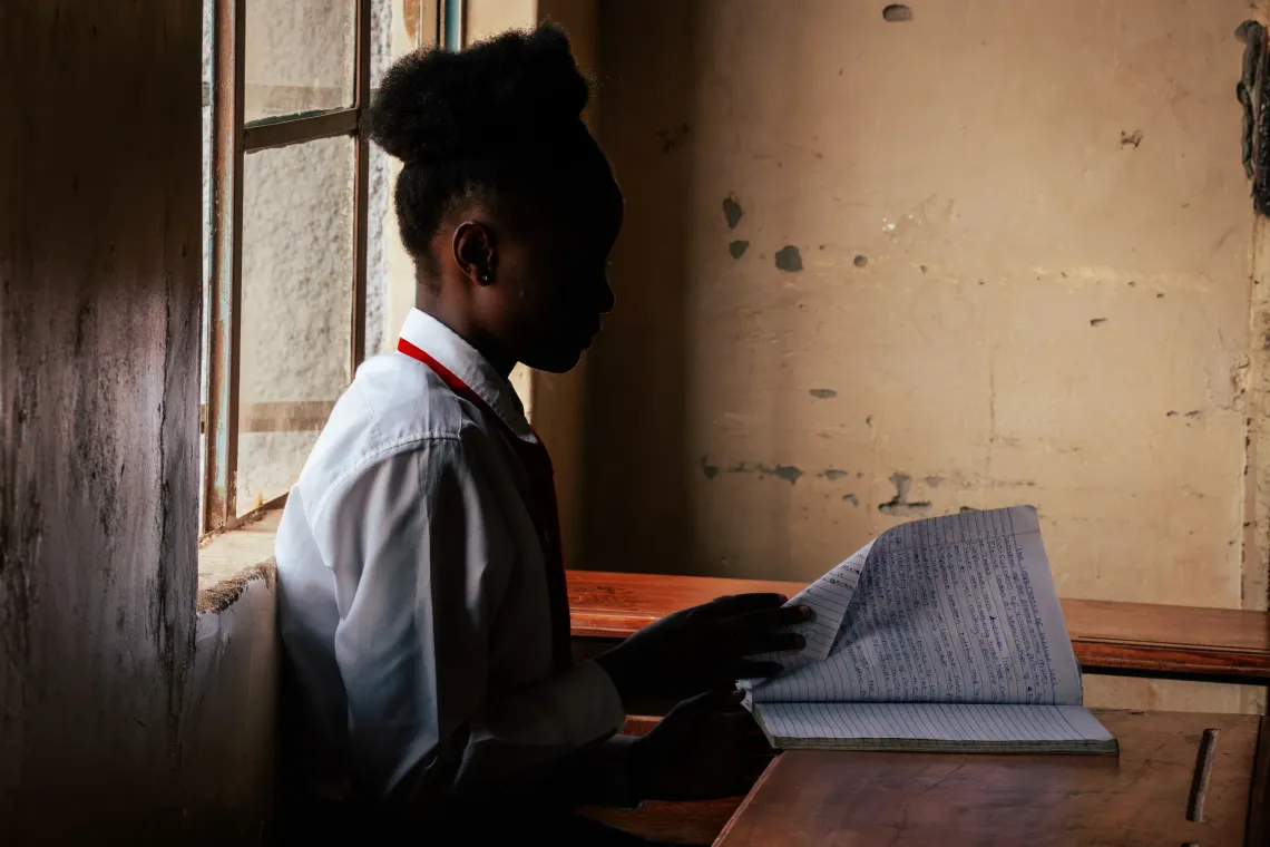 Joy* sits in her classroom as she participates in the interview.