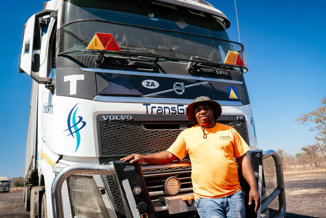 Long-distance truck driver Joseph Muzikiti poses in front of his truck in Monze. 