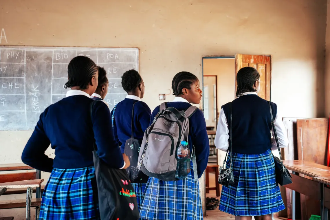Five girls leave the classroom after a productive focus group discussion, having shared their voices and experiences.