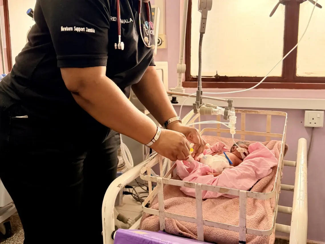Dr. Mala provides routine care to a newborn in a neonatal ward.