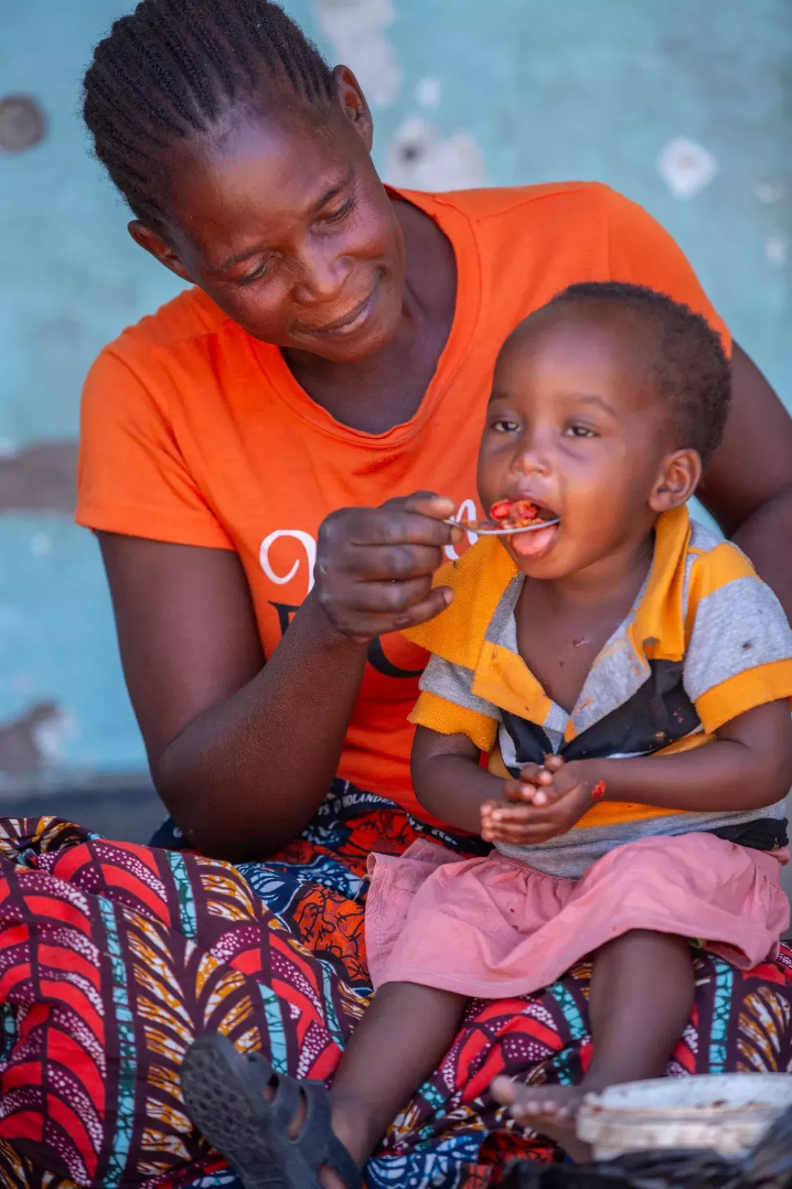 A mother feeding her child.