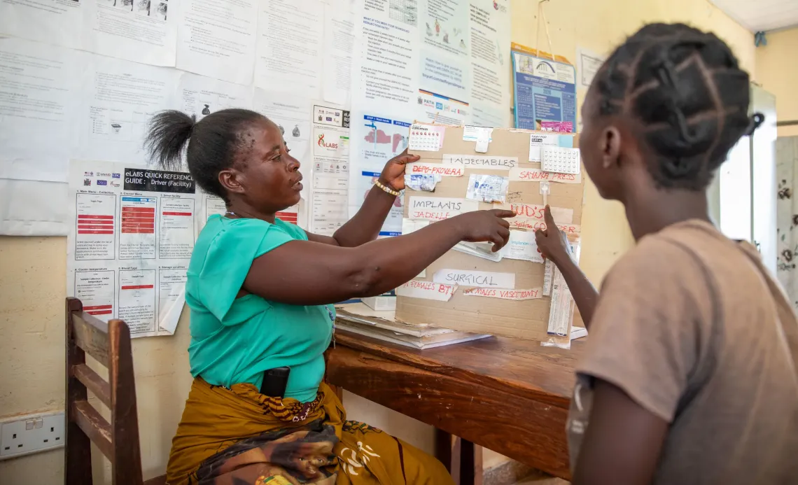 Community Health Worker Uweka Nkhoma (L) explains contraceptive options to an adolescent client at Chimutende Rural Health Facility. 