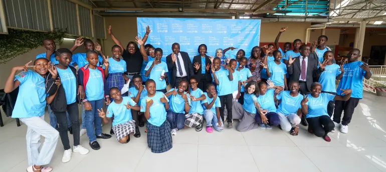 Child delegates to the national commemoration of WCD2025 share a light moment with dignitaries at the event in Lusaka, Zambia.