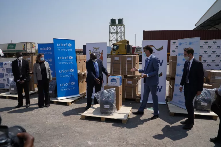 Health supplies being handed over with branding
