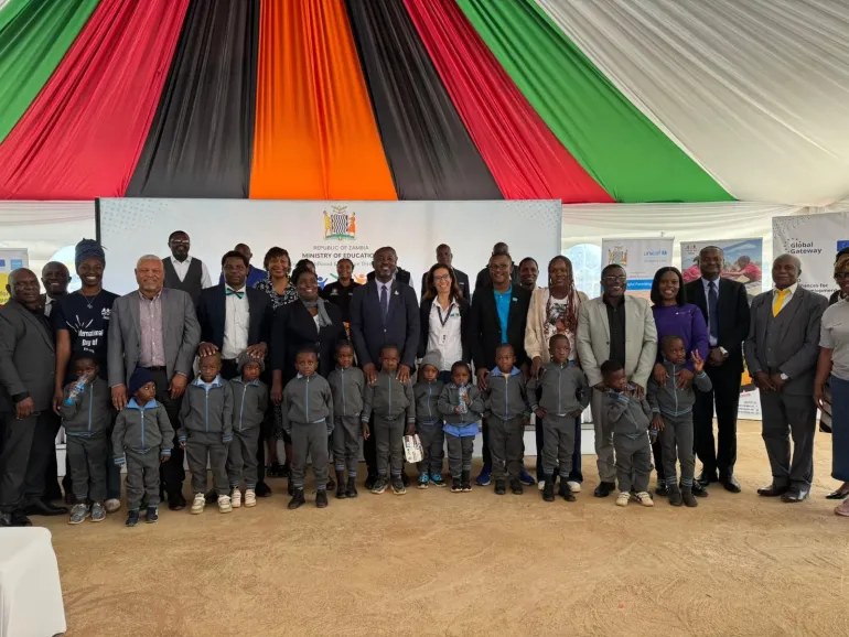 Government officials, UNICEF representatives, partners, and young children pose for a group photo during an International Day of Play event in Zambia.