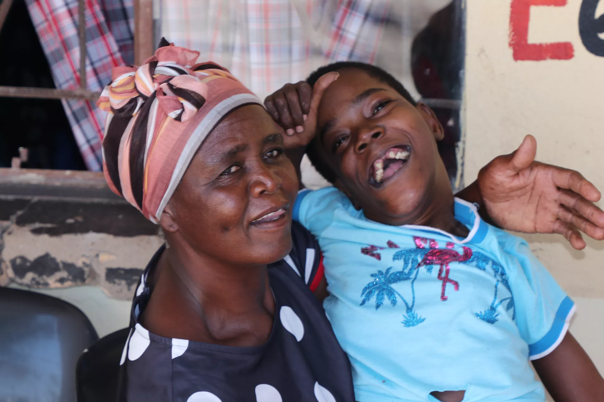A mother with her daughter at a center for supporting children living with disability