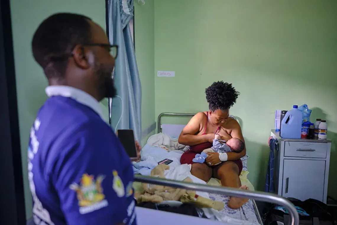 Ronald looks at his wife and new born son